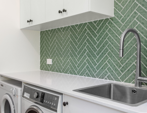 renovated laundry room with green tiles